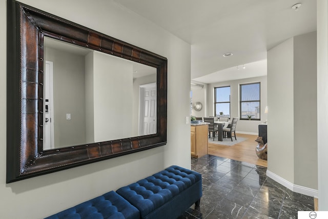 corridor with dark hardwood / wood-style flooring