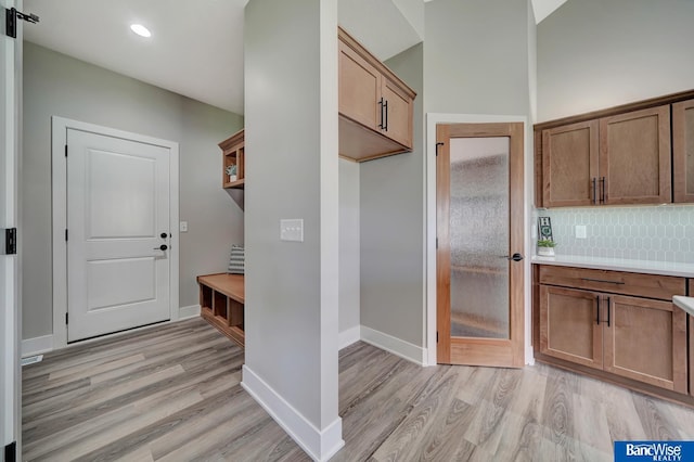 kitchen with backsplash and light wood-type flooring