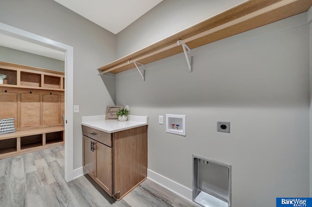 clothes washing area featuring electric dryer hookup, hookup for a washing machine, and light hardwood / wood-style flooring