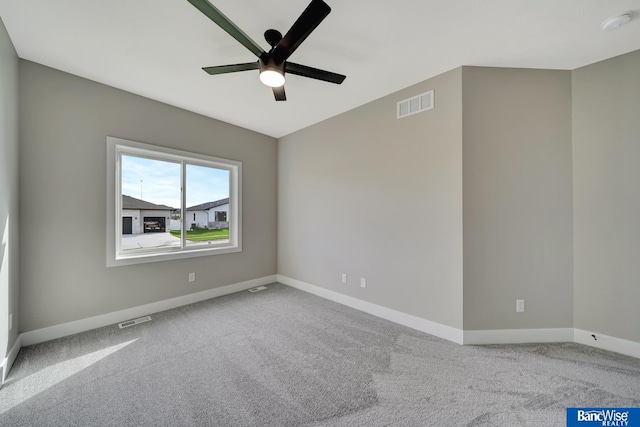 empty room with ceiling fan and carpet