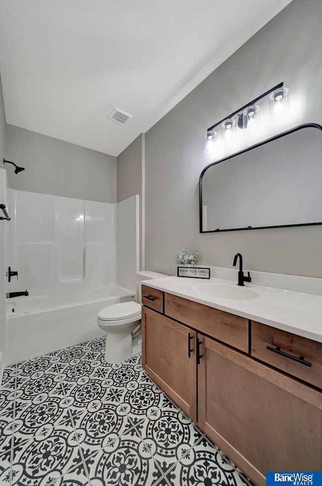 full bathroom featuring tile patterned floors, vanity, toilet, and shower / washtub combination