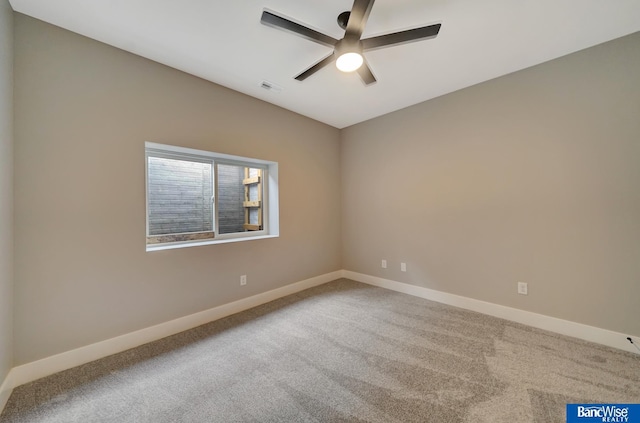 spare room featuring ceiling fan and carpet floors