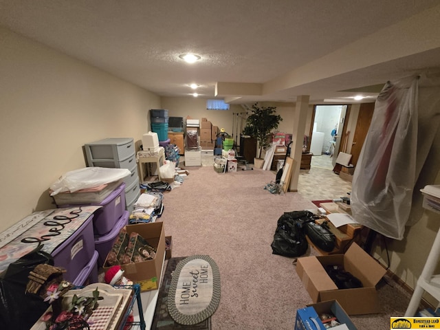 miscellaneous room with light carpet and a textured ceiling