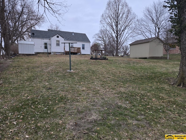 view of yard featuring a deck and a storage unit