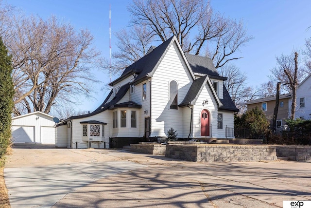 view of front facade featuring a garage and an outdoor structure