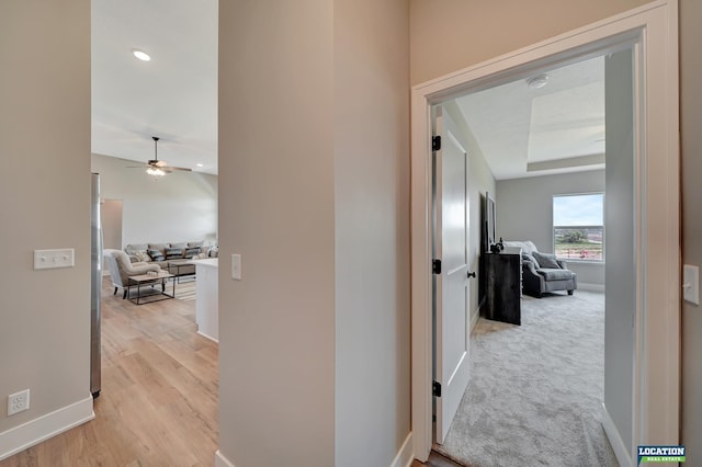 corridor with light hardwood / wood-style floors