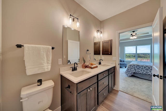 bathroom with ceiling fan, toilet, vanity, and hardwood / wood-style flooring