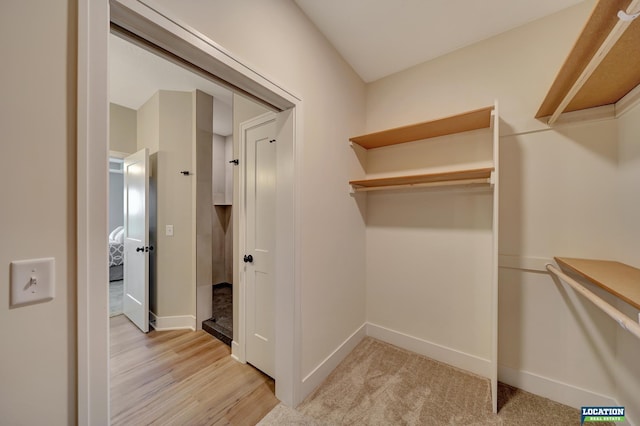 spacious closet with light hardwood / wood-style floors