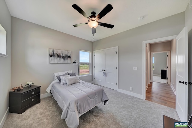 carpeted bedroom featuring a closet and ceiling fan