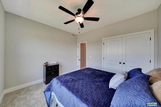 carpeted bedroom with a closet and ceiling fan