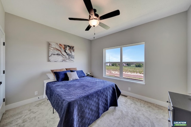 bedroom featuring ceiling fan and light colored carpet