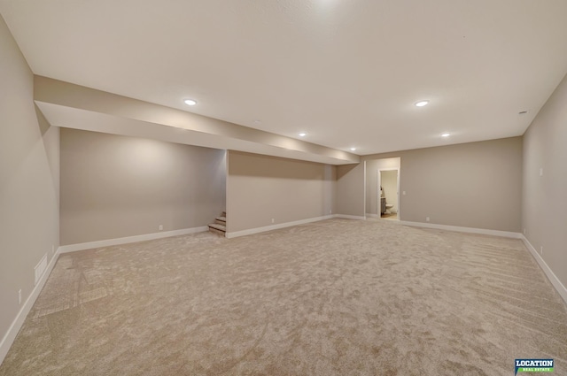 basement featuring light carpet