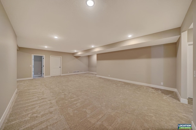 basement featuring light colored carpet