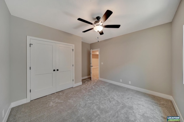 unfurnished bedroom featuring light carpet, a closet, and ceiling fan