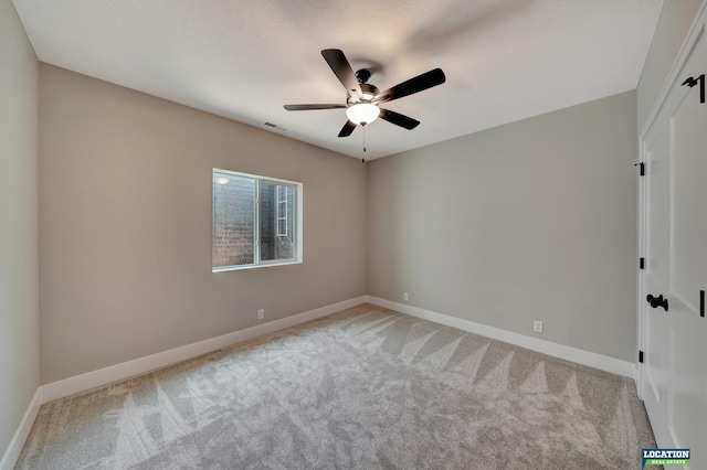 carpeted empty room with ceiling fan and a textured ceiling