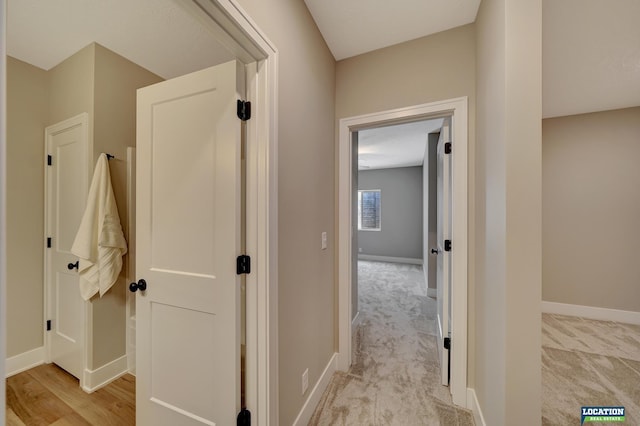 hallway featuring light carpet