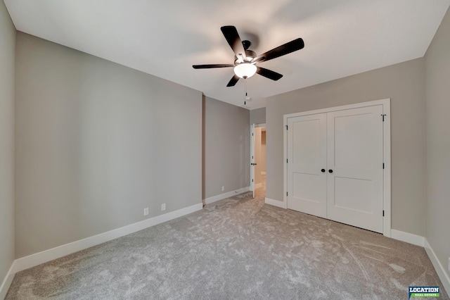 unfurnished bedroom with light carpet, a closet, and ceiling fan