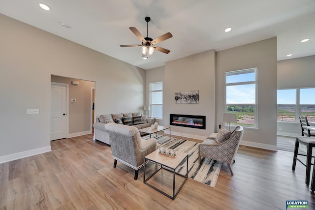 living room featuring ceiling fan and light hardwood / wood-style flooring