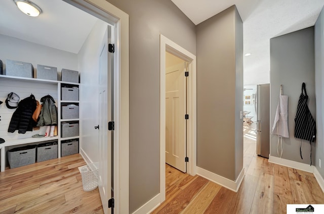 mudroom with light hardwood / wood-style flooring