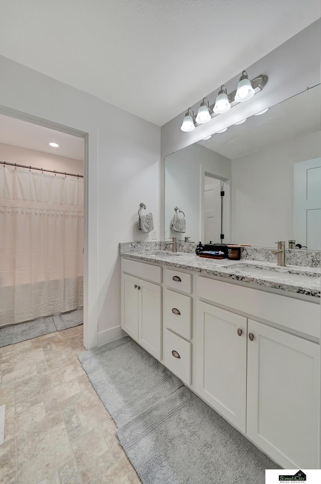 bathroom with a shower with curtain and vanity