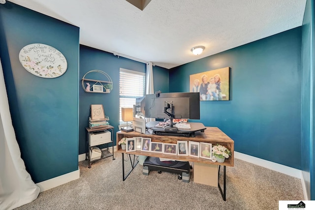 carpeted office featuring a textured ceiling