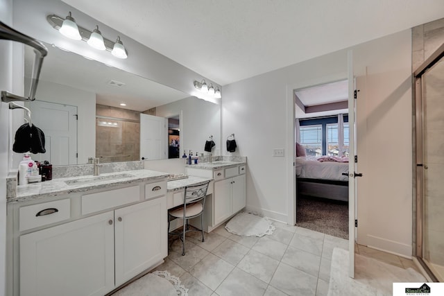 bathroom with tile patterned flooring, a textured ceiling, vanity, and a shower with door