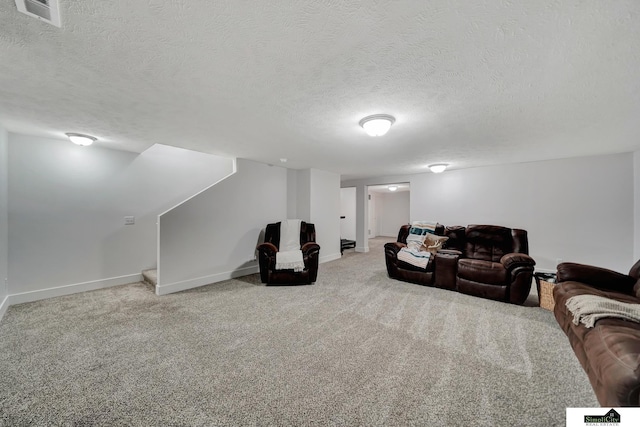 carpeted living room featuring a textured ceiling