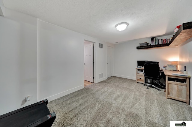 office space with light colored carpet and a textured ceiling