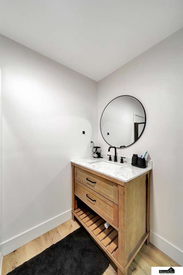 bathroom featuring hardwood / wood-style floors and vanity