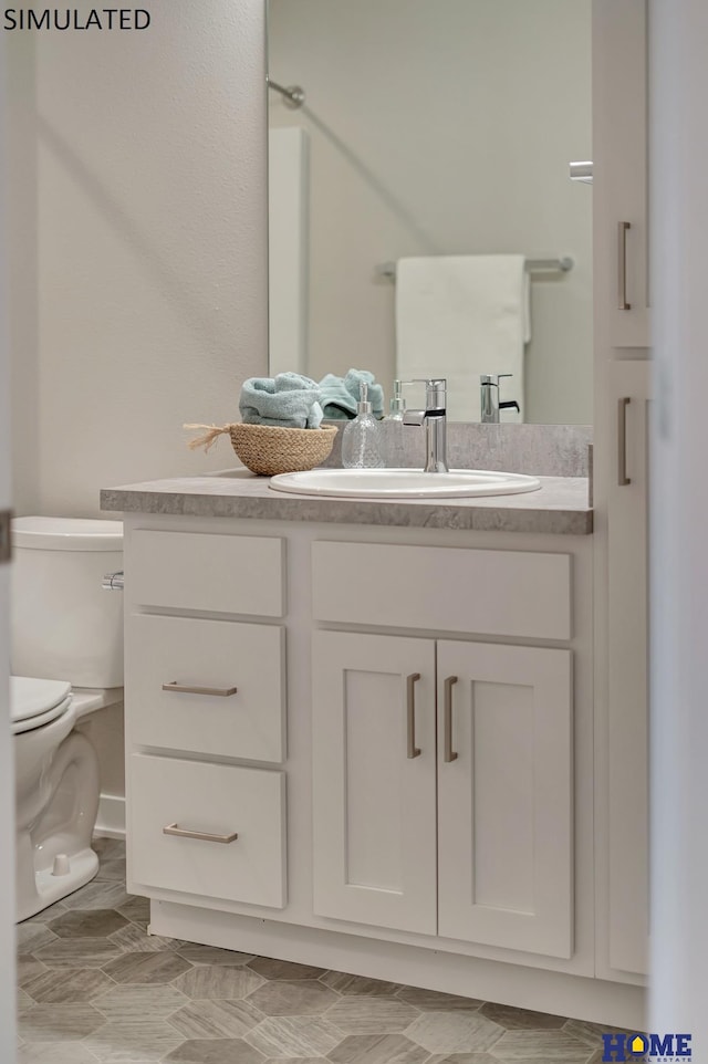 bathroom with vanity and toilet