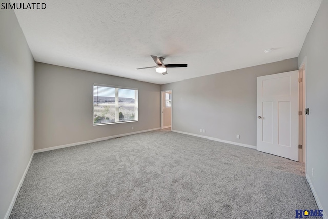 carpeted spare room featuring a textured ceiling and ceiling fan