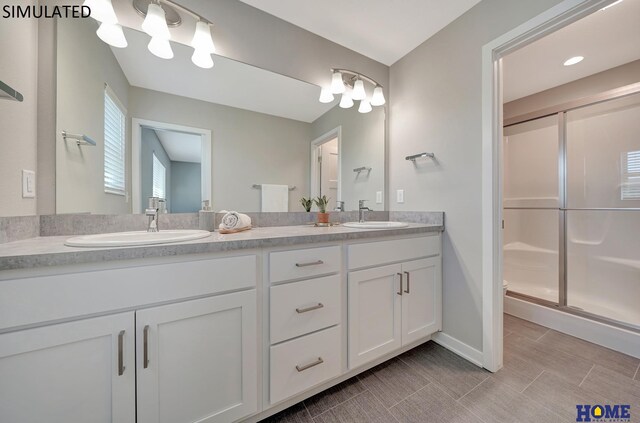 bathroom featuring vanity and an enclosed shower