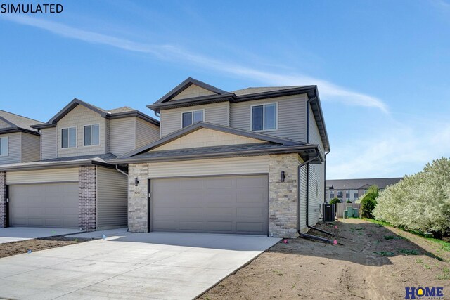 view of front of property featuring a garage and central air condition unit