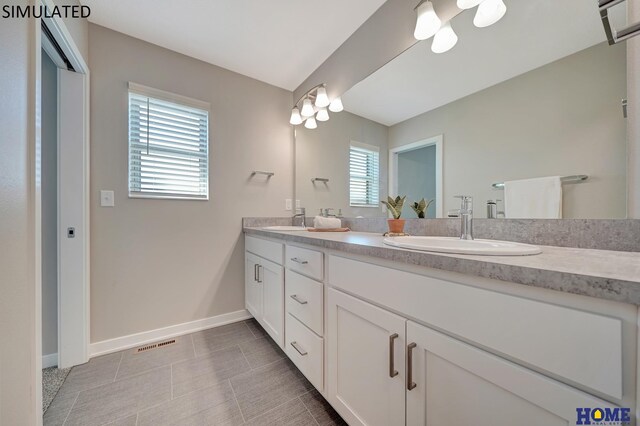 bathroom featuring tile patterned flooring and vanity