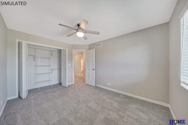 unfurnished bedroom with ceiling fan, a closet, and carpet floors