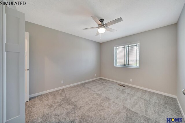 unfurnished room featuring light carpet and ceiling fan