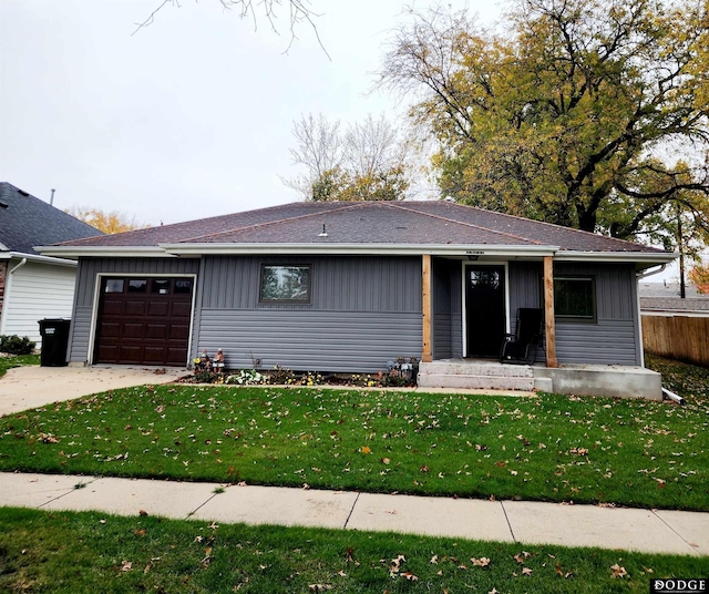 single story home featuring a garage and a front yard