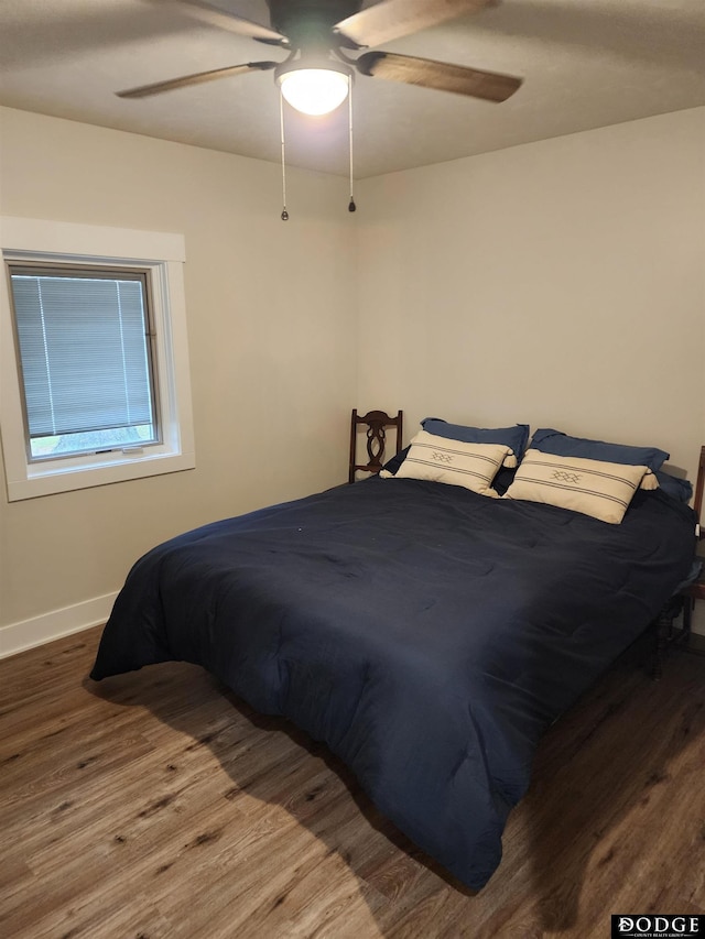 bedroom with hardwood / wood-style flooring and ceiling fan