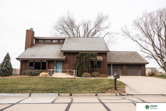 view of front of house featuring a front yard and a garage