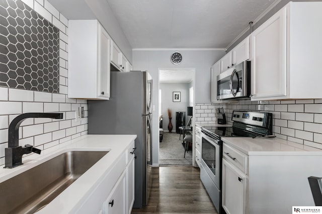 kitchen featuring white cabinets, sink, appliances with stainless steel finishes, and dark wood-type flooring