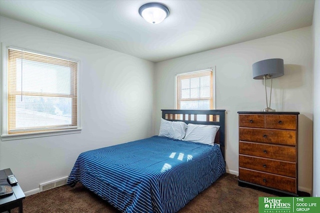 bedroom featuring dark carpet