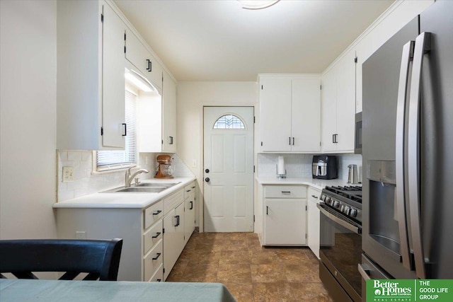 kitchen featuring sink, white cabinetry, backsplash, and appliances with stainless steel finishes