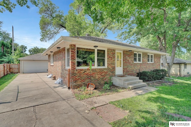 view of front of home with a garage, a front lawn, and an outdoor structure