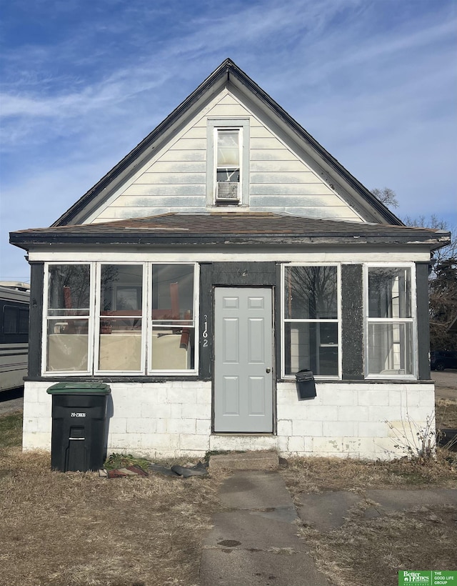 view of front of house with a sunroom