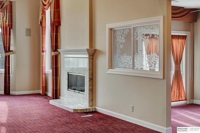 unfurnished living room featuring a fireplace and carpet flooring