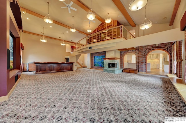 unfurnished living room featuring light carpet, high vaulted ceiling, ceiling fan, and beamed ceiling