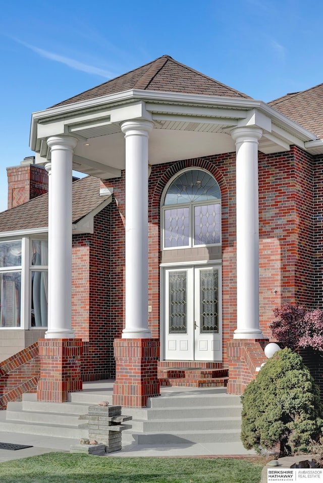 entrance to property featuring french doors and a porch