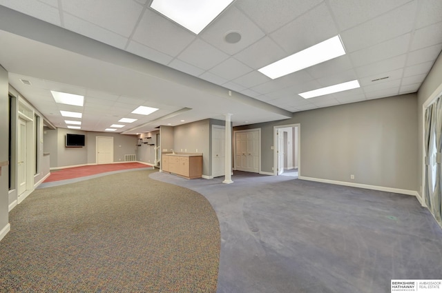 carpeted spare room featuring a paneled ceiling