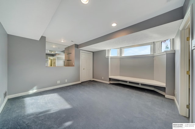 basement with dark colored carpet