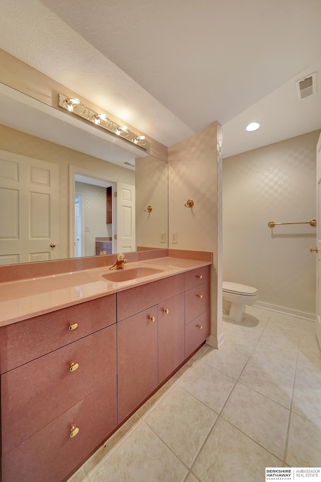 bathroom with tile patterned floors, vanity, and toilet